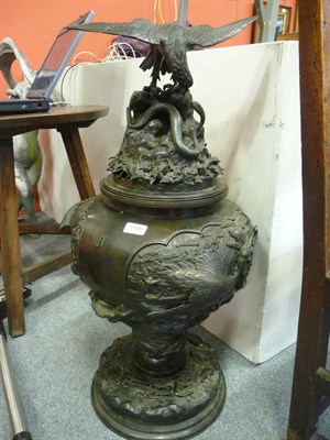 Lot 1106 - A very large Japanese bronze vase and cover on a pedestal base, profusely decorated in relief...