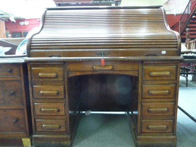 Lot 1127 - An oak roll top desk