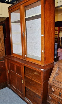 Lot 1164 - Oak bookcase top, an early 20th century oak cabinet with sliding panel doors