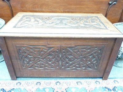 Lot 1166 - A carved blanket box decorated with dragon heads and initials JBL, dated 1912