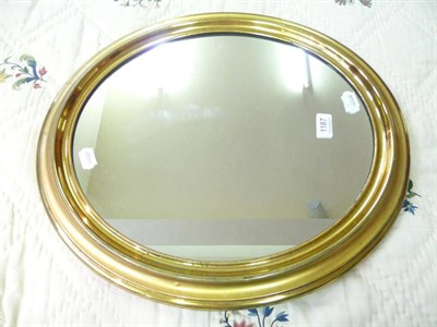 Lot 1187 - Victorian oval mirror in lacquered brass frame