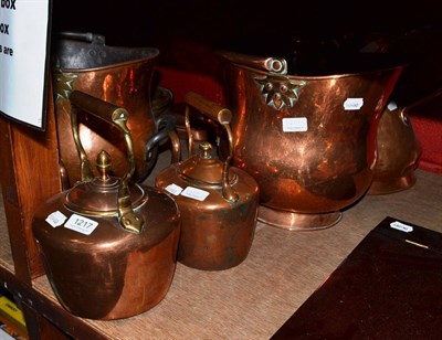 Lot 1217 - Two copper coal buckets, two warming pans, a gallon jug and two copper kettles