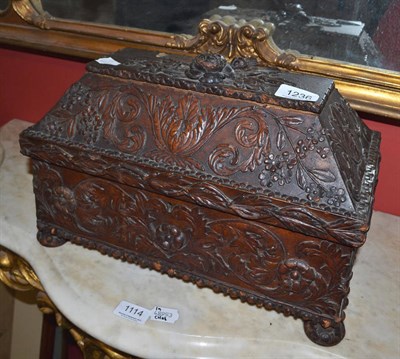 Lot 1236 - A carved and stained wood tea chest with fitted interior with two lidded compartments and a...