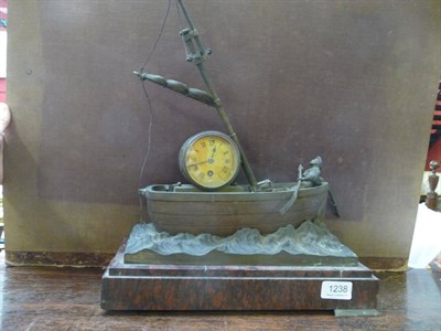 Lot 1238 - A novelty timepiece depicting a fisherman in a boat (a.f.)