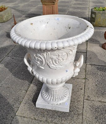 Lot 1281 - A cream painted cast iron garden urn of campana form with double loop handles and reeded brass...