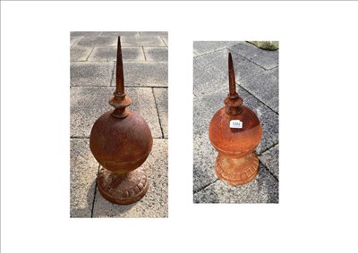 Lot 1282 - A pair of metal finials on cast bases