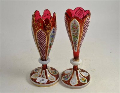 Lot 26 - A pair of 19th century cranberry and floral painted glass vases