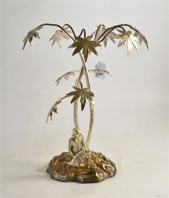 Lot 32 - An Elkington style white metal table centre piece as an Eastern figure with a musket beneath...