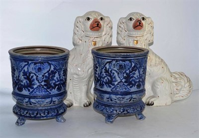 Lot 56 - A pair of Staffordshire spaniels and a pair of German stoneware planters on stands