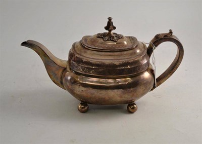 Lot 74 - A late George III silver teapot engraved with leaf border on four ball feet, London 1812, 21cm