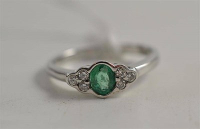 Lot 103 - An 18ct white gold emerald and diamond ring