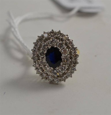 Lot 109 - An 18ct gold sapphire and diamond cluster ring