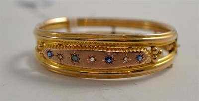 Lot 111 - A 9ct gold sapphire and diamond bangle, Chester, 1907