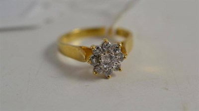 Lot 116 - An 18ct gold nine stone diamond cluster ring