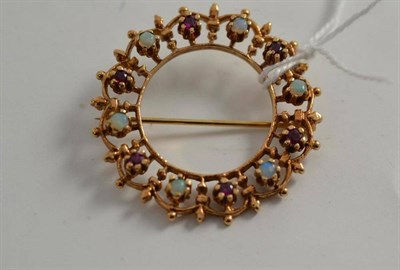 Lot 128 - A 9ct gold opal and garnet hoop brooch
