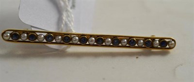 Lot 135 - A 15ct gold sapphire and seed pearl brooch