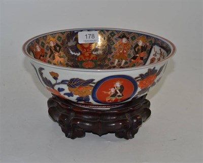Lot 178 - A 19th century Japanese porcelain bowl decorated in Imari colours with ships and figures, with...