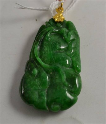 Lot 263 - A Chinese emerald jade lotus and fish pendant with yellow metal mount