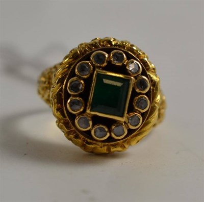 Lot 265 - An 18ct gold emerald and diamond ring