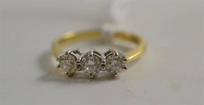 Lot 275 - A diamond three stone ring (and original receipt)