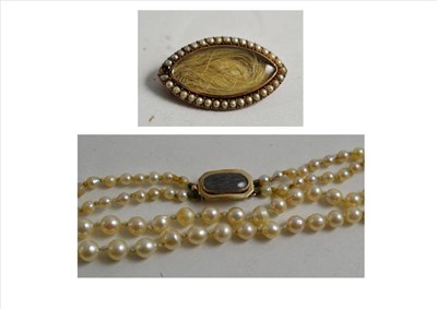 Lot 285 - A strand of pearls with a locket clasp and a mourning brooch (a.f.)