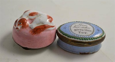 Lot 303 - Oval enamel patch box and cover 'Love her who Gives This Toy' and an enamel box of a spaniel (2)