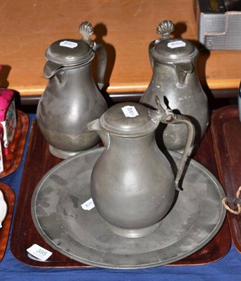 Lot 395 - An 18th century pewter circular plate and three baluster jugs