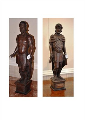 Lot 431 - A pair of German carved oak figures, in Renaissance style, as Roman soldiers wearing helmets...