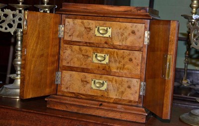 Lot 454 - A Victorian walnut two door cabinet fitted with three drawers