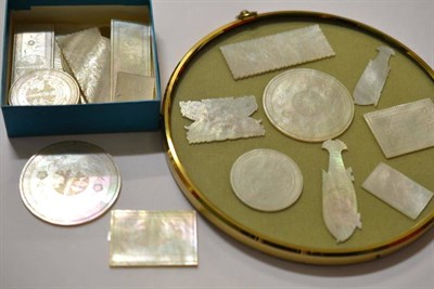 Lot 476 - A collection of twenty-four Chinese export mother-of-pearl gaming tokens, two large circular...