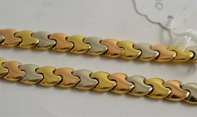 Lot 491 - An 18ct gold fancy link, three colour necklace