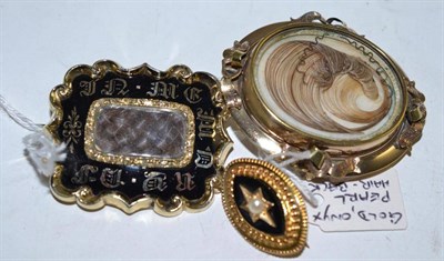 Lot 499 - Three mourning brooches; one with plaited hair inset locket panel, engraved to the reverse...