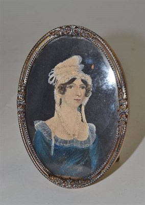 Lot 529 - A naive portrait miniature on card of a lady