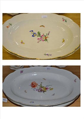 Lot 577 - A pair of Berlin oval porcelain meat plates each decorated with butterflies and spring flowers...