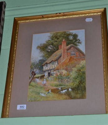 Lot 682 - Watercolour by Claude Strachan, half-timbered cottage with children beside hollyhocks