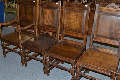 Lot 832 - Twelve oak chairs with panel backs and boarded seats including two carvers