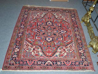 Lot 927 - Heriz rug of unusual size, Persian Azerbaijan, the tomato field with indigo medallions framed...