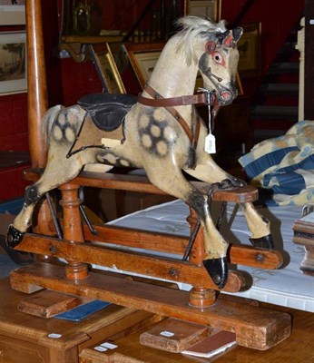 Lot 936 - A small late 19th century rocking horse painted dapple grey on trestle base