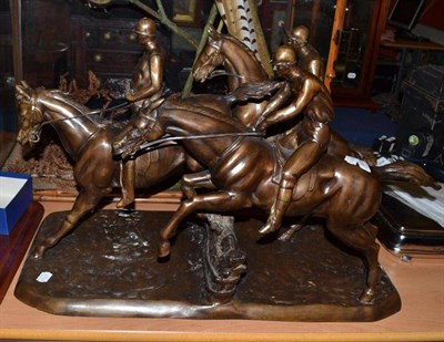 Lot 939 - Modern bronzed figure group as jockeys on horseback