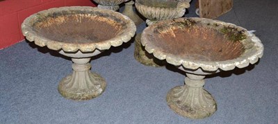 Lot 949 - Pair of cast iron urns with gadrooned bases