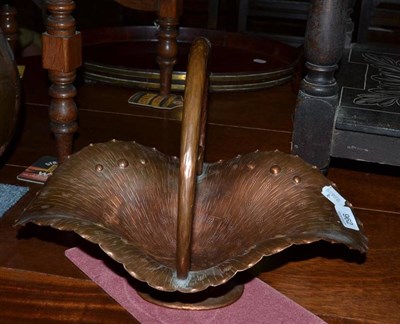 Lot 962 - A Egidio Casagrande copper flower basket with stylised handle, 40cm long