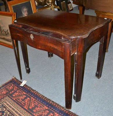 Lot 985 - A George III mahogany writing or architect's table raised on castors.