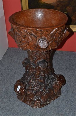 Lot 987 - Red stoneware tree trunk plant stand