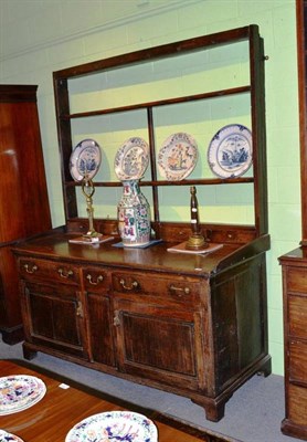 Lot 1001 - A George III oak enclosed dresser and rack, late 18th century, raised on bracket feet, 181cm by...