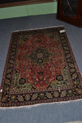 Lot 1016 - Ghom silk rug, central Persia, candy field scrolling floral vines around an apple green pole...