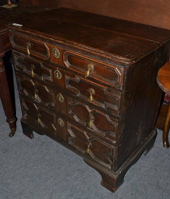 Lot 1025 - An 17th century style oak straight front chest of drawers, with four geometric moulded drawers,...