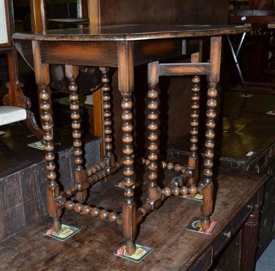 Lot 1026 - A 1920's drop leaf table with bobbin turned legs