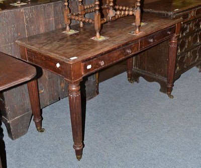 Lot 1027 - A mid 19th century mahogany writing table fitted two drawers on reeded legs