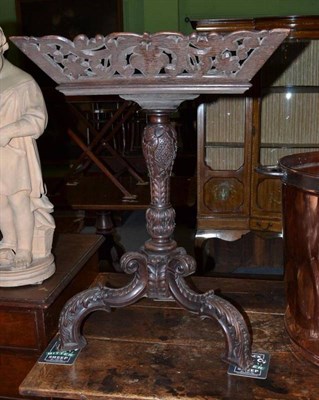 Lot 1037 - A late 19th century carved oak tripod table with rectangular foliate decorated top section