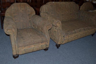 Lot 1064 - An early 20th century three piece suite raised on castors